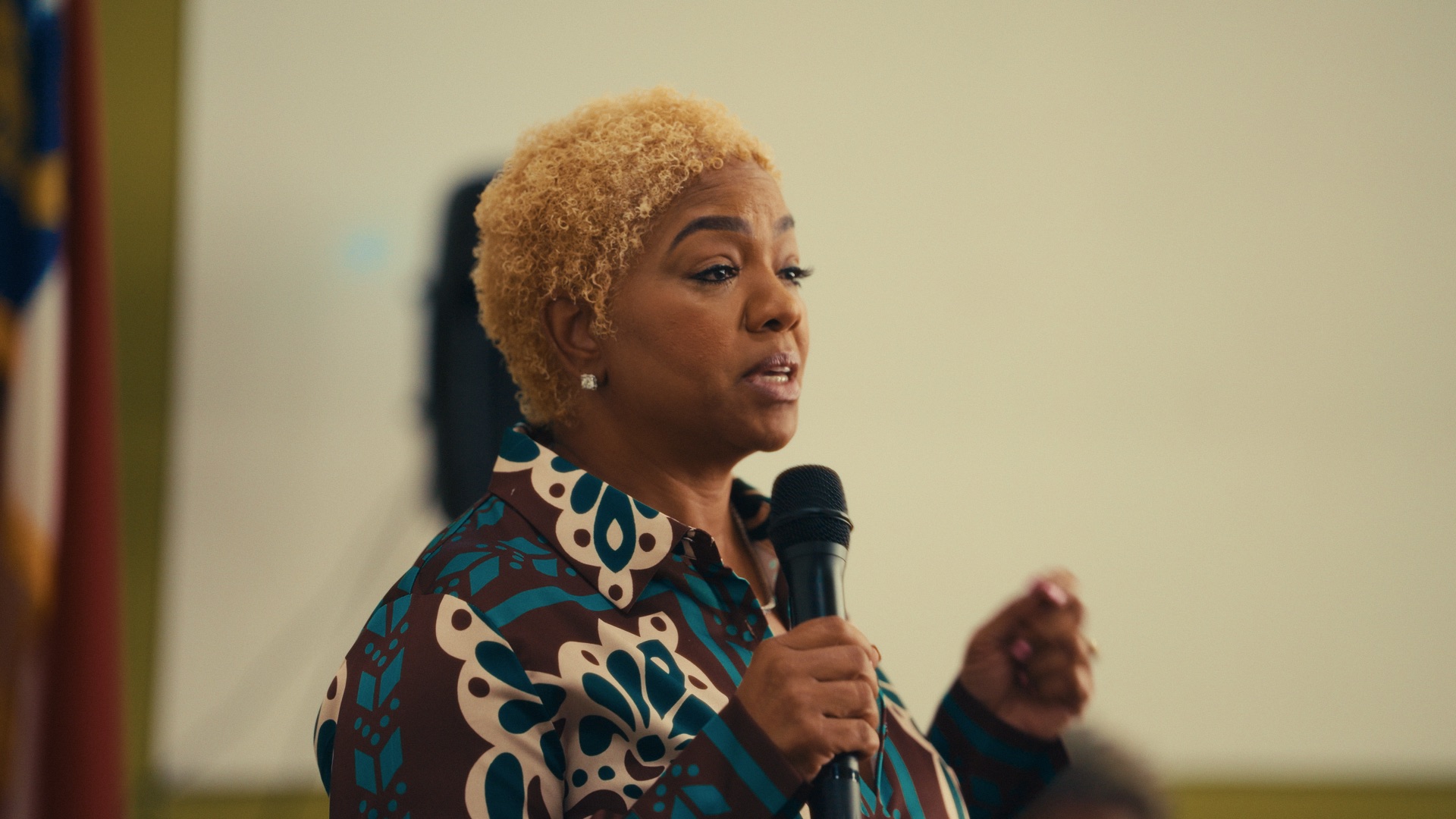 Speaker sharing a message into a microphone during an event